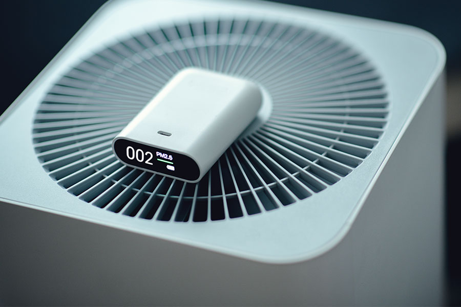 Indoor air quality monitor placed on an air purifier for home air quality testing in Barboursville, WV